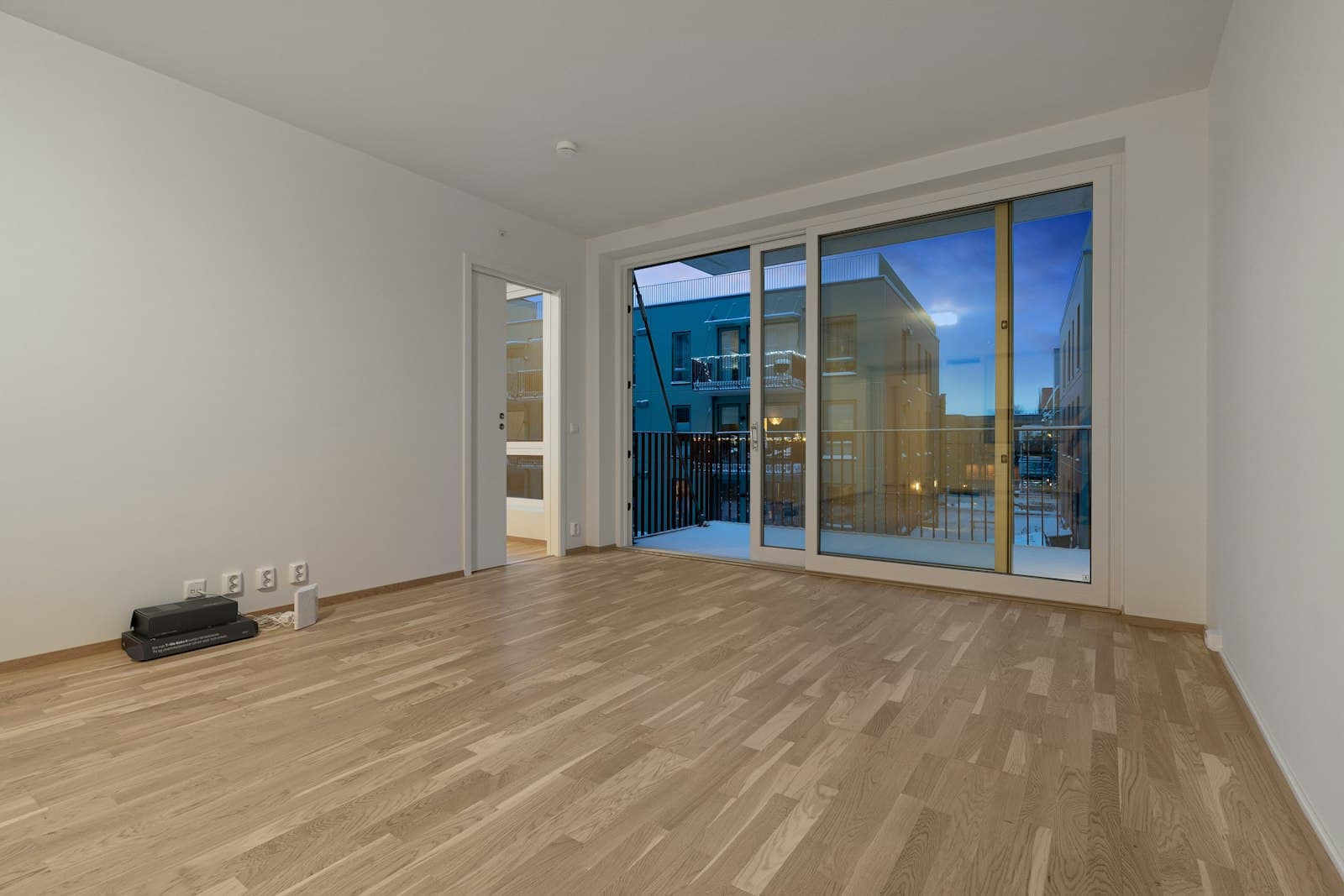 Bright, empty modern living space with floor-to-ceiling windows, ready for its next tenant