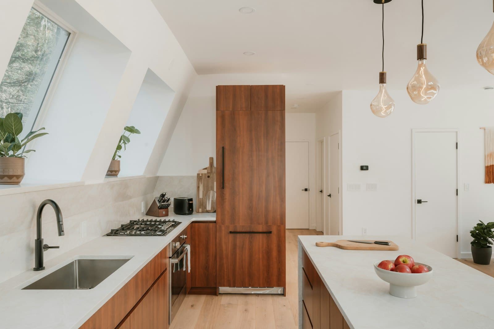 Newly finished luxury kitchen with wood cabinetry, marble counters, and skylights